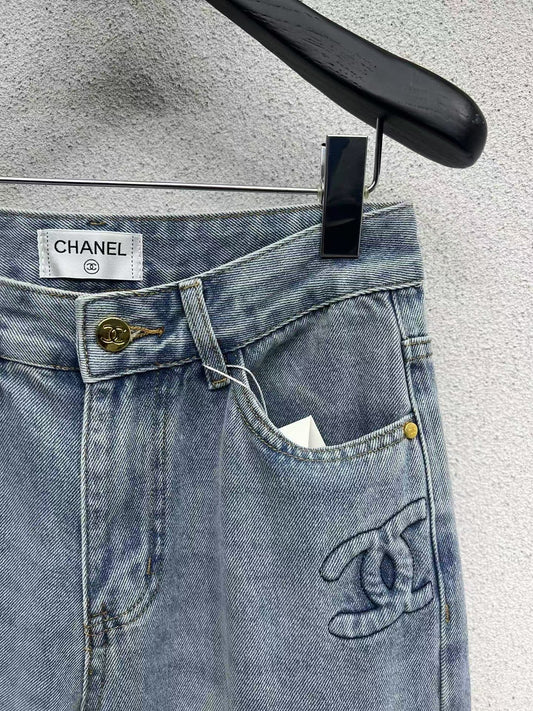 Denim trousers with embossed logo on pocket