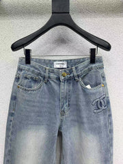 Denim trousers with embossed logo on pocket