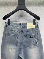 Denim trousers with embossed logo on pocket